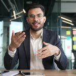 Webcam view. Confident businessman in a formal suit talking on a video call looking at camera sitting in office. Entrepreneur has a business meeting. Manager speaks remotely at an online conference